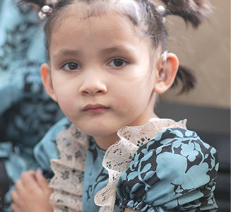 Young child wearing a hearing device