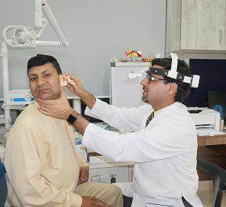 ENT specialist examining a patient's ear