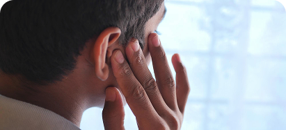 Clinician examining a young patient's ear